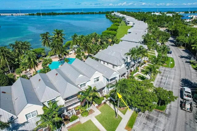an aerial view of a house with a yard and lake view