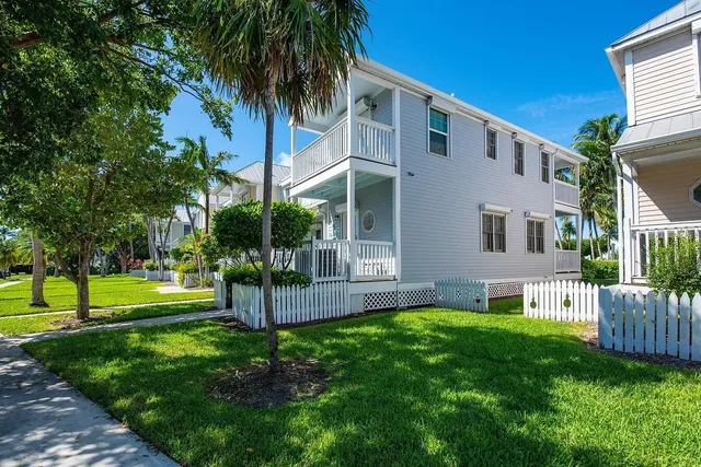 a view of a house with a yard and a patio