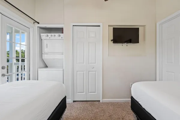 a bedroom with a bed and a flat screen tv