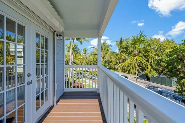 a bedroom with a bed and a flat tv screen on the dresser