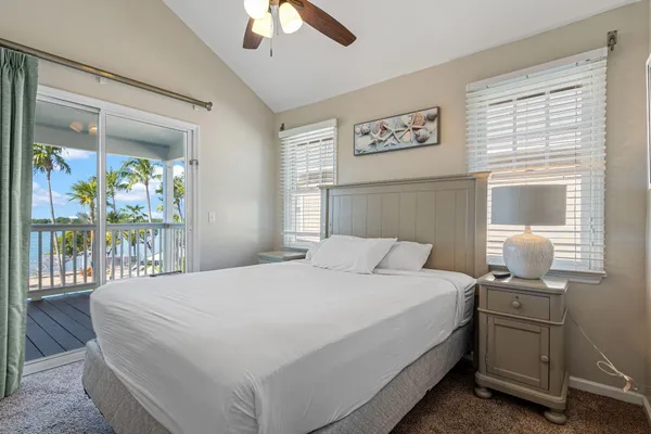 a bathroom with a granite countertop sink toilet a mirror and bathtub
