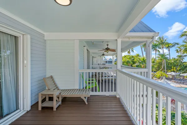 a view of a chairs and table in the balcony