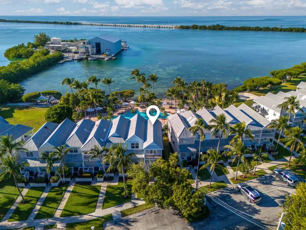 a view of a swimming pool with outdoor seating and a garden