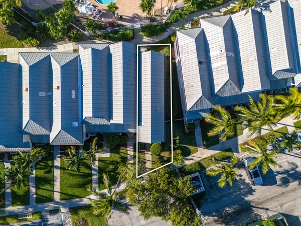 an aerial view of a residential houses with outdoor space and lake view
