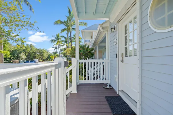 a view of a pathway of a house with wooden floor and fence