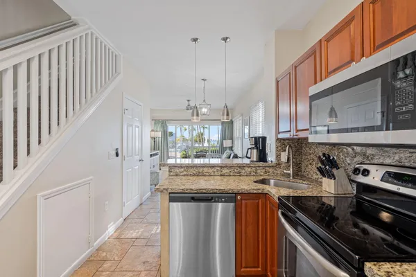 a kitchen with stainless steel appliances granite countertop a stove and a sink