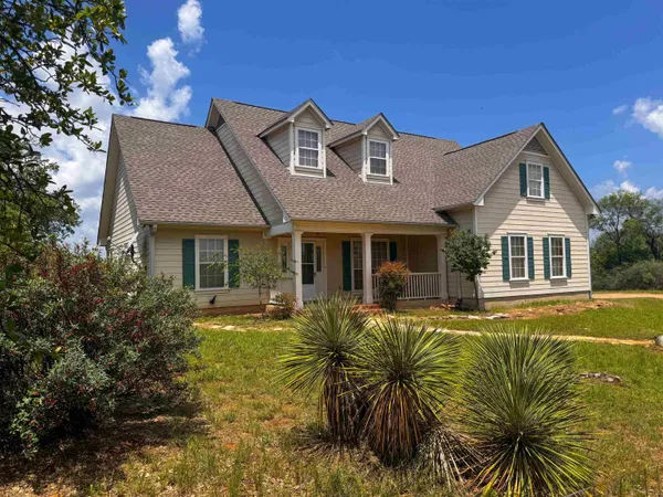 a front view of house with yard outdoor seating and barbeque oven