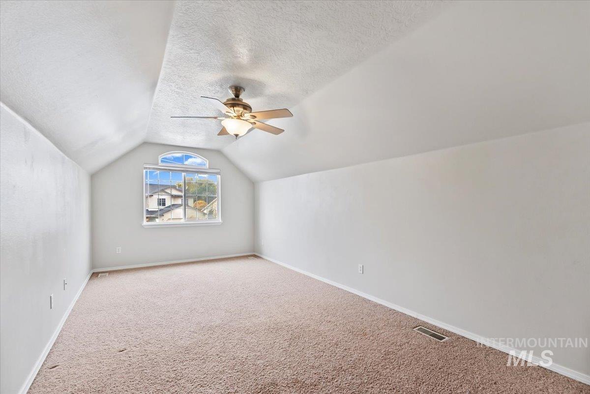 16608 Old Friendship Way Caldwell, ID 83607 - Photo 21 of 32 Bonus room featuring carpet floors, vaulted ceiling, a ceiling fan, and a textured ceiling