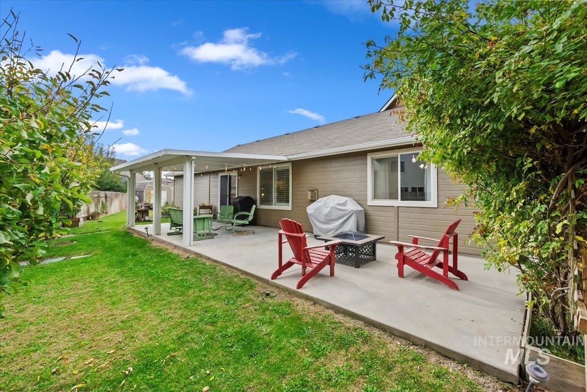 16608 Old Friendship Way Caldwell, ID 83607 - Photo 25 of 32 Rear view of house featuring a patio area and an outdoor fire pit
