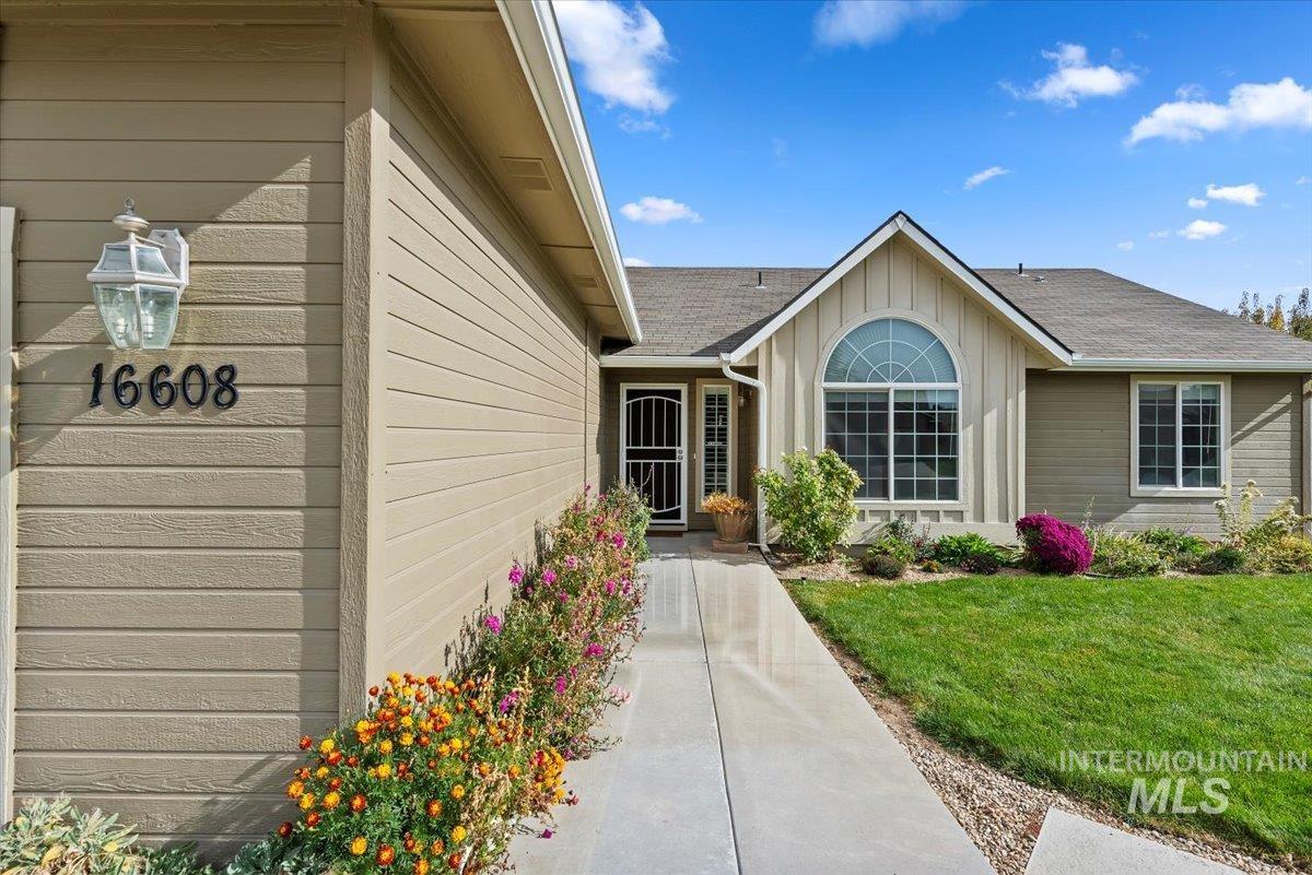 16608 Old Friendship Way Caldwell, ID 83607 - Photo 3 of 32 Entrance to property featuring a lawn, roof with shingles, and board and batten siding