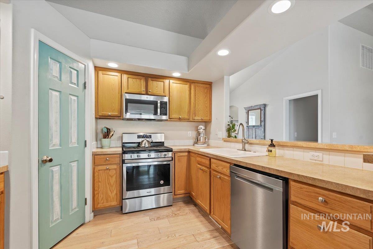 16608 Old Friendship Way Caldwell, ID 83607 - Photo 9 of 32 Kitchen with stainless steel appliances, light countertops, recessed lighting, light wood-style flooring, and brown cabinetry