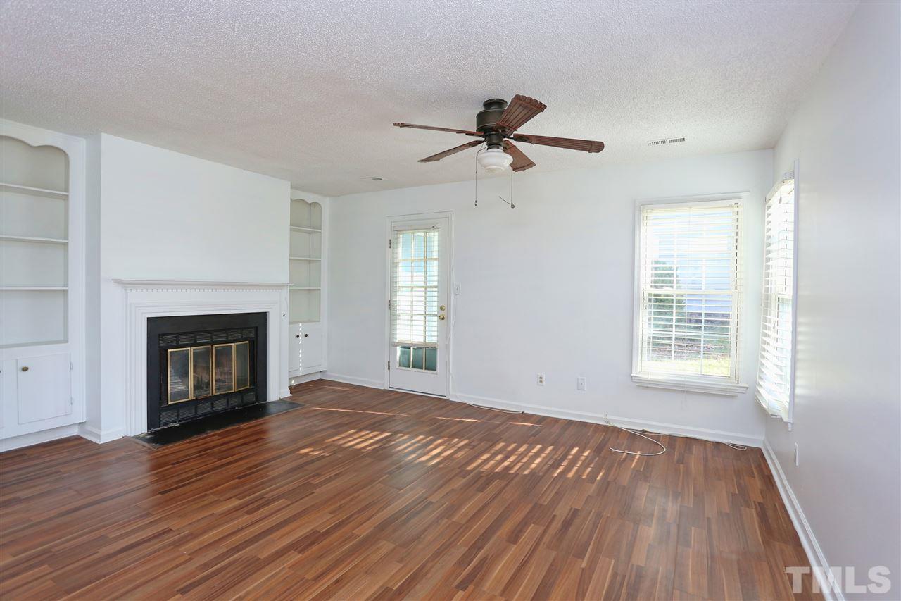 4465 Roller Court Raleigh, NC 27604 - Photo 2 of 23 a view of empty room with wooden floor and fireplace