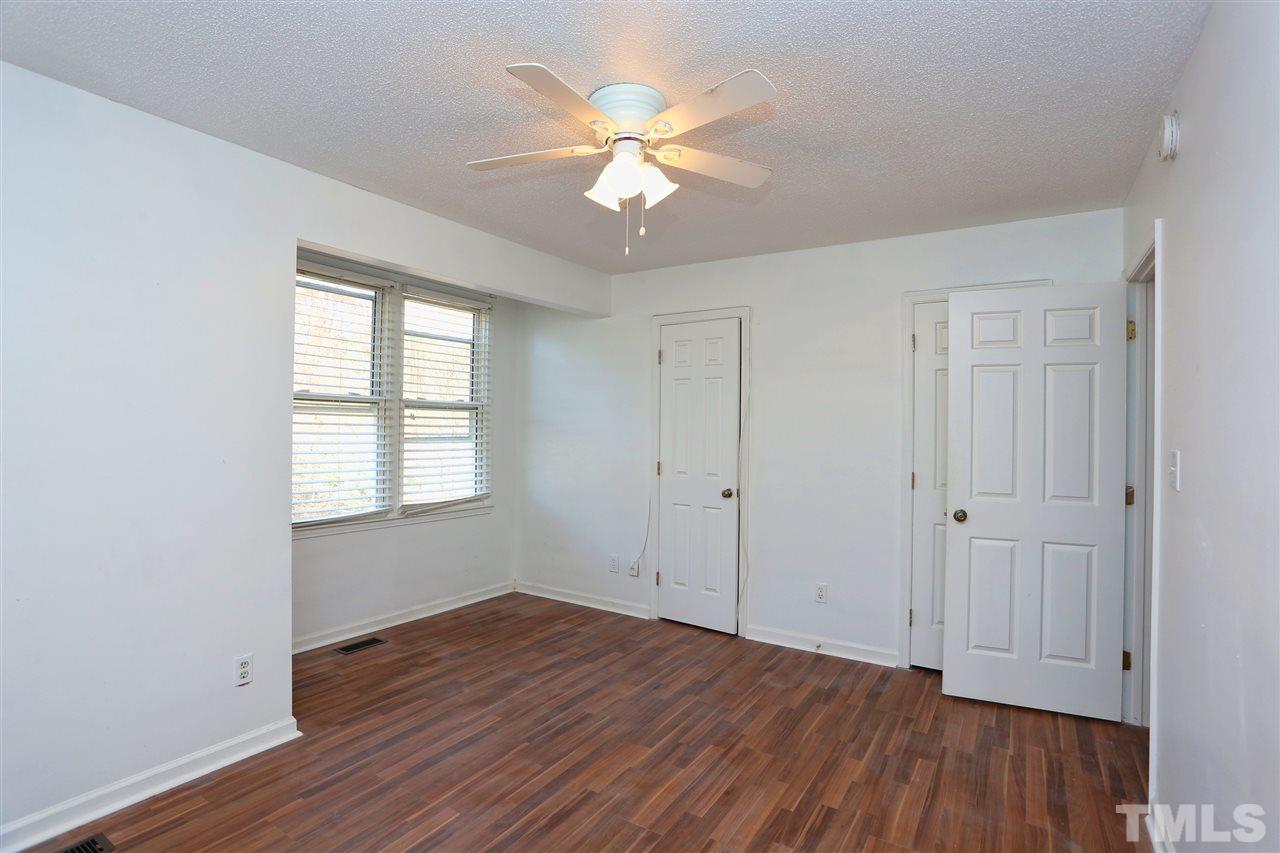 4465 Roller Court Raleigh, NC 27604 - Photo 11 of 23 an empty room with wooden floor and ceiling fan