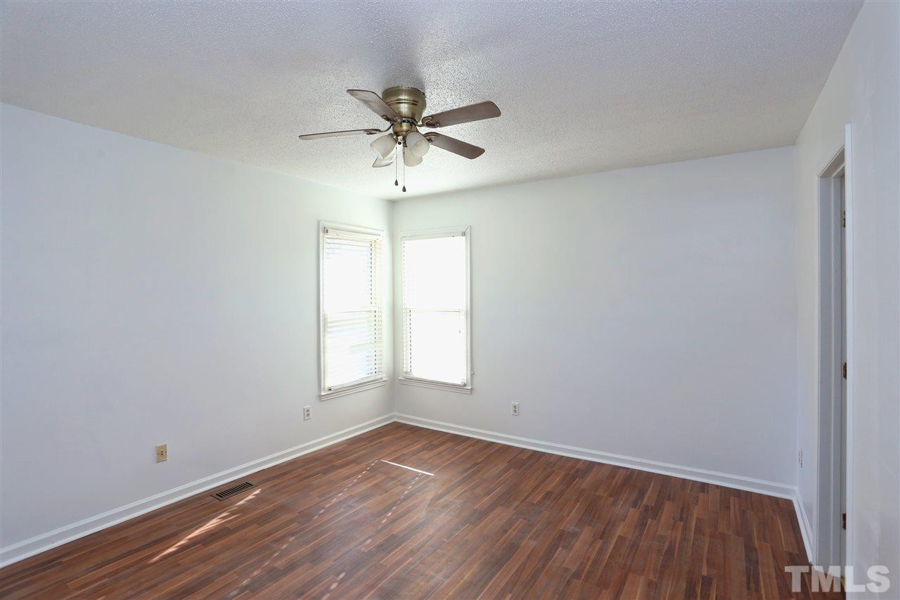 4465 Roller Court Raleigh, NC 27604 - Photo 14 of 23 an empty room with wooden floor and windows