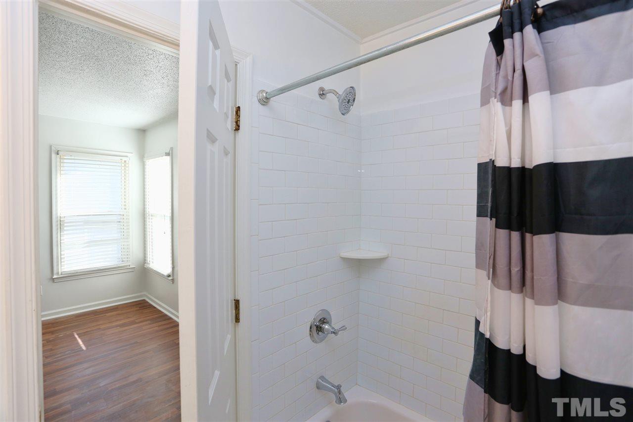4465 Roller Court Raleigh, NC 27604 - Photo 17 of 23 a bathroom with a shower and a tub