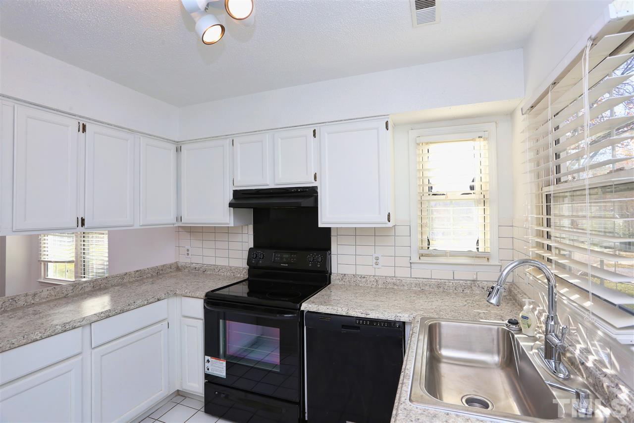 4465 Roller Court Raleigh, NC 27604 - Photo 4 of 23 a kitchen with stainless steel appliances granite countertop a sink stove and cabinets