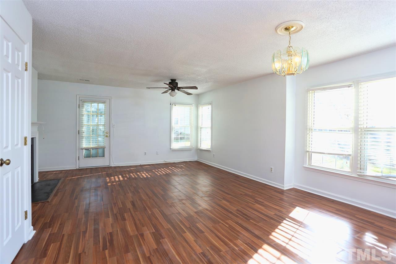 4465 Roller Court Raleigh, NC 27604 - Photo 6 of 23 a view of an empty room with a window and wooden floor