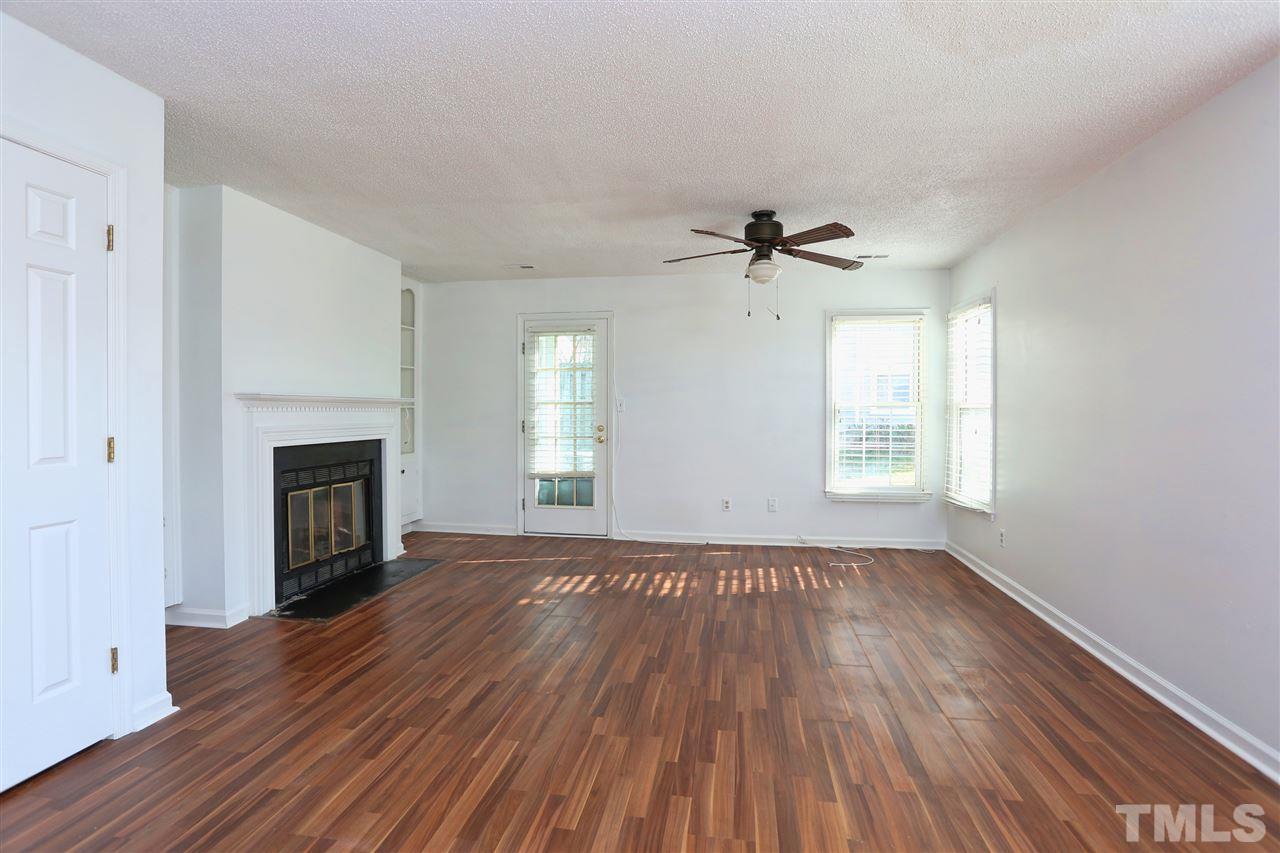 4465 Roller Court Raleigh, NC 27604 - Photo 7 of 23 an empty room with windows a fireplace