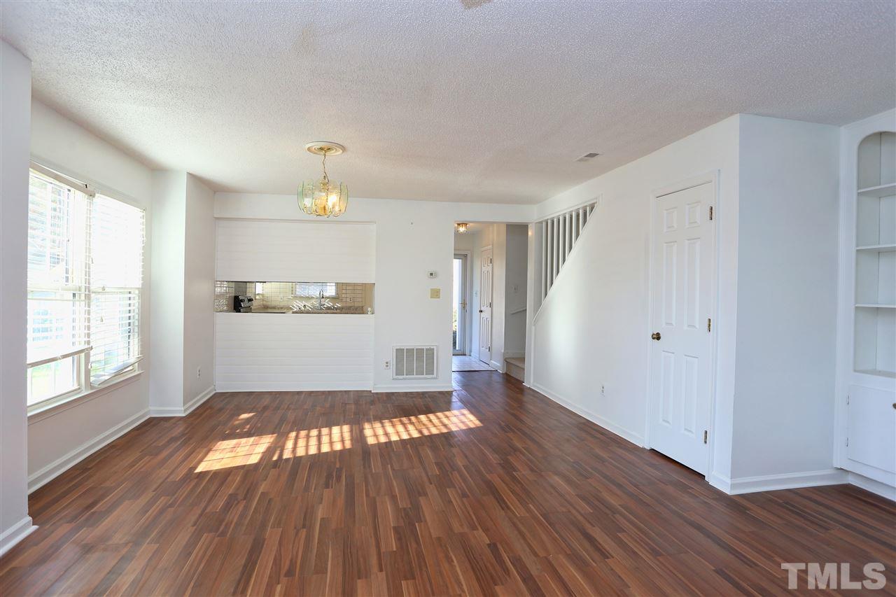4465 Roller Court Raleigh, NC 27604 - Photo 8 of 23 an empty room with wooden floor cabinet and windows