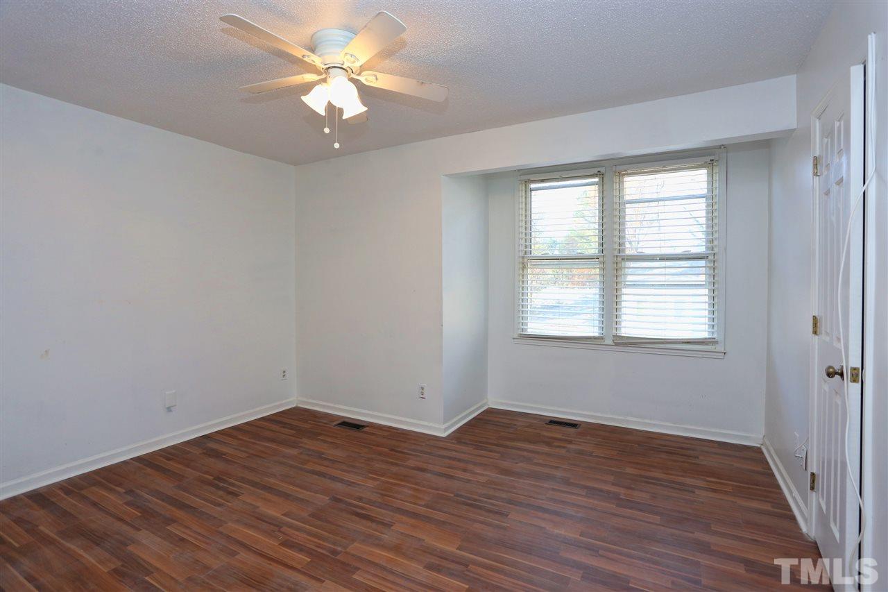 4465 Roller Court Raleigh, NC 27604 - Photo 10 of 23 wooden floor in an empty room with a window
