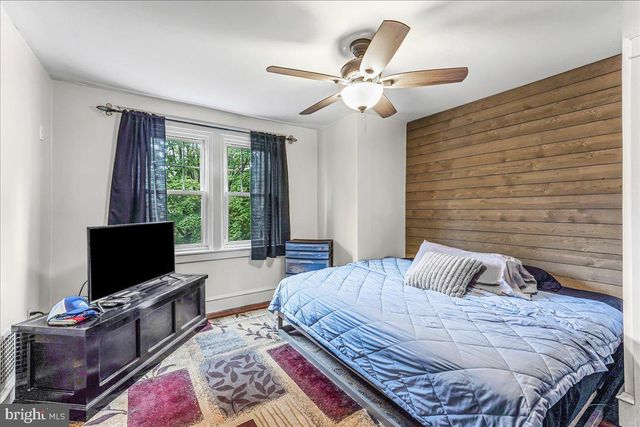 a bedroom with a bed and flat screen tv