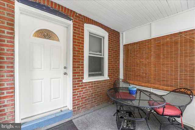 a view of a door with a bench and wooden bench