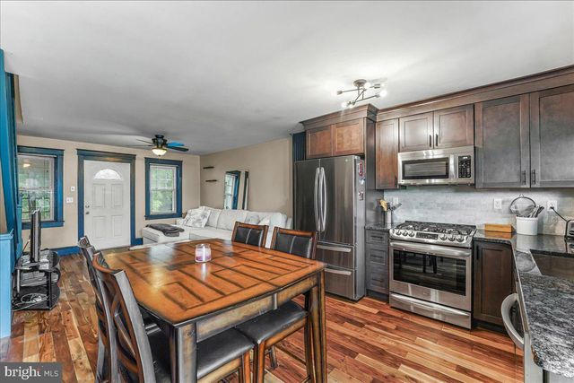 a kitchen with a stove a sink and a refrigerator