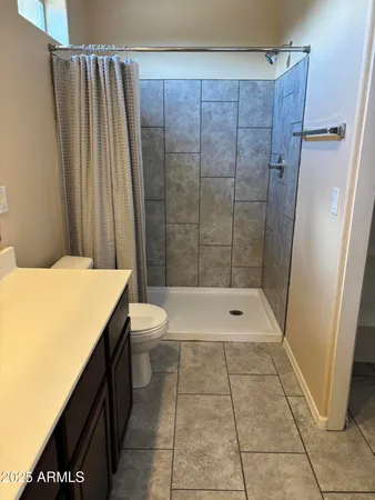 a bathroom with a shower and a toilet