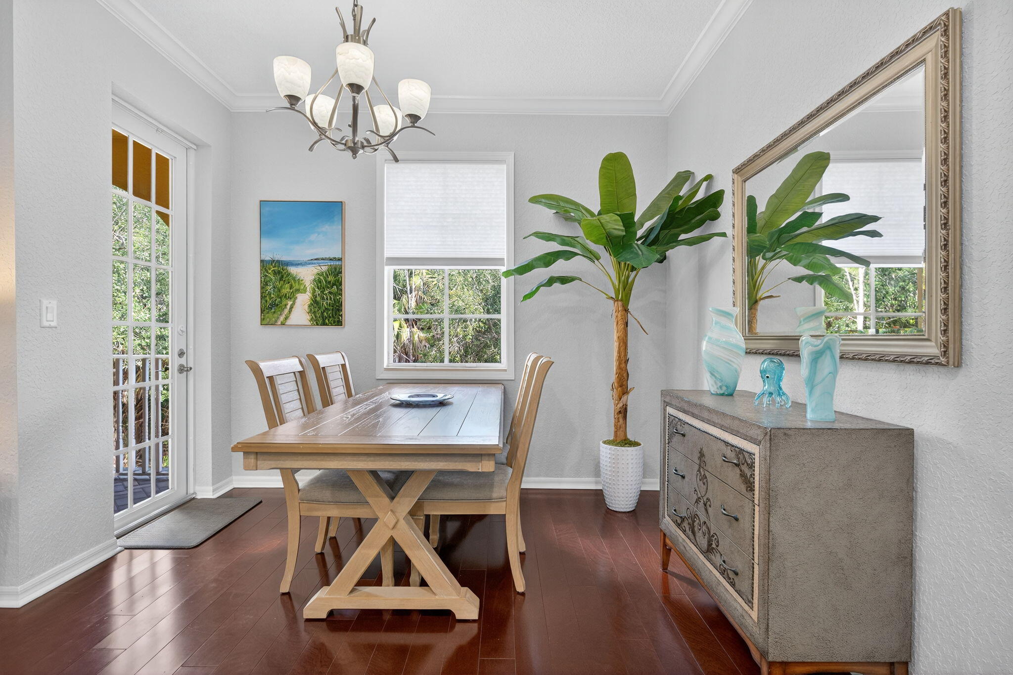 141 Seagrape Drive, Unit 203 Jupiter, FL 33458 - Photo 12 of 39 a dining room with furniture potted plants and wooden floor