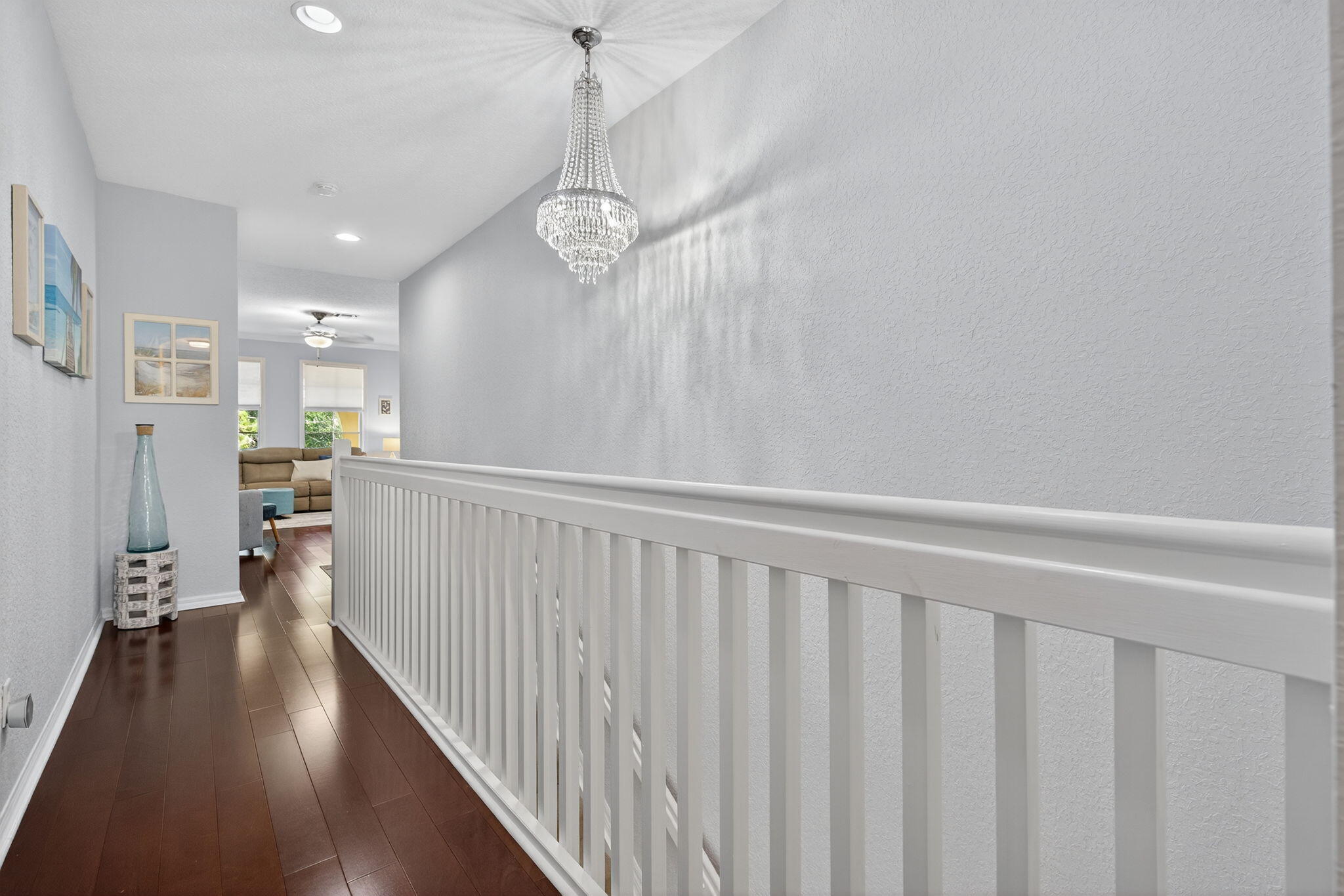 141 Seagrape Drive, Unit 203 Jupiter, FL 33458 - Photo 24 of 39 a view of a hallway with wooden floor and a chandelier