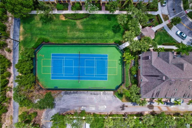 an aerial view of multiple houses with yard