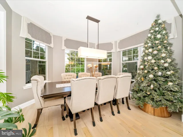 a spacious bedroom with a large bed and a chandelier