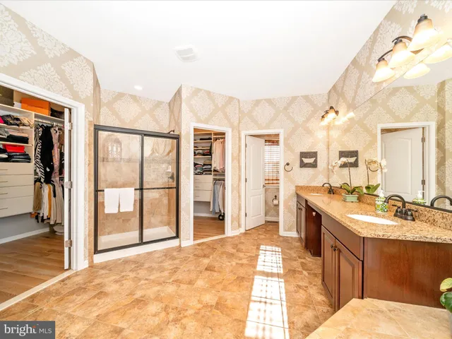 a view of a patio with couches and umbrella