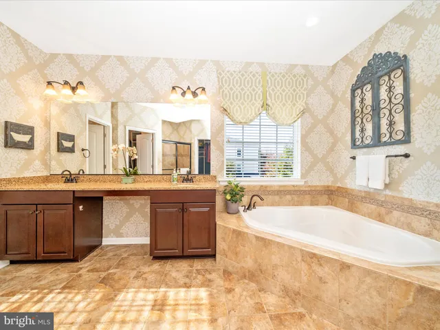 a view of a patio with couches and table under an umbrella