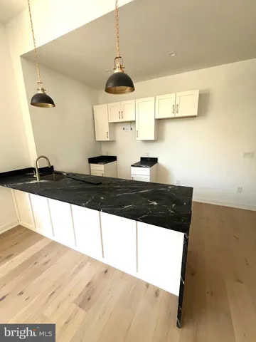 a kitchen with a sink a stove and cabinets