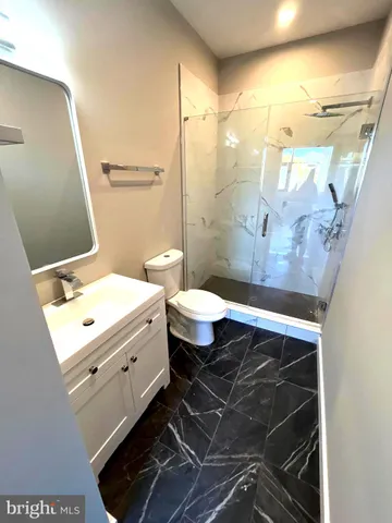 a bathroom with a sink mirror vanity and toilet
