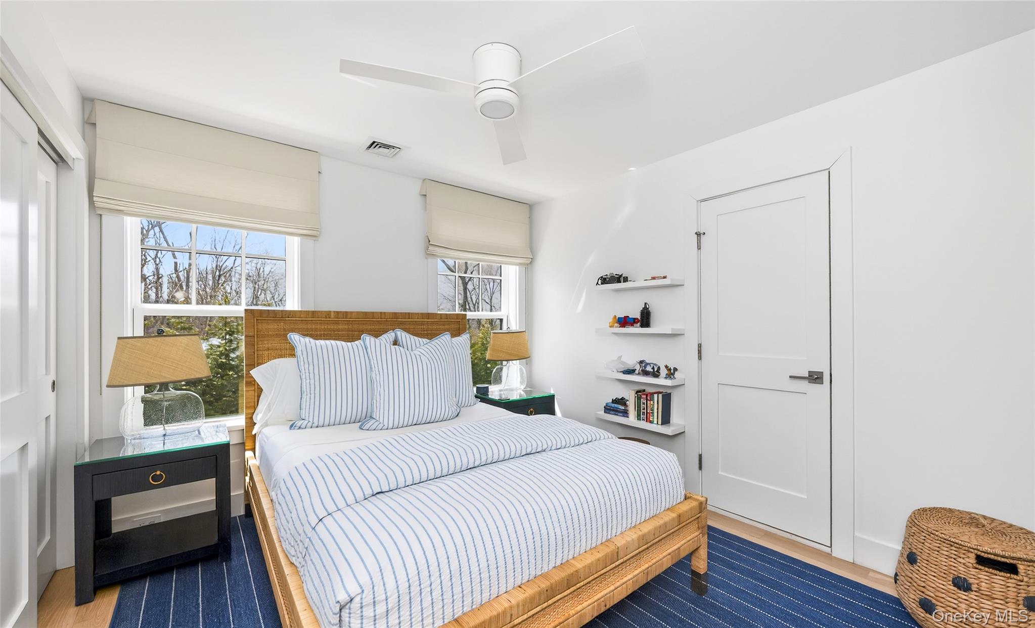 17 Bayview Road Southampton, NY 11968 - Photo 28 of 39 a bedroom with a large bed and a wooden floor