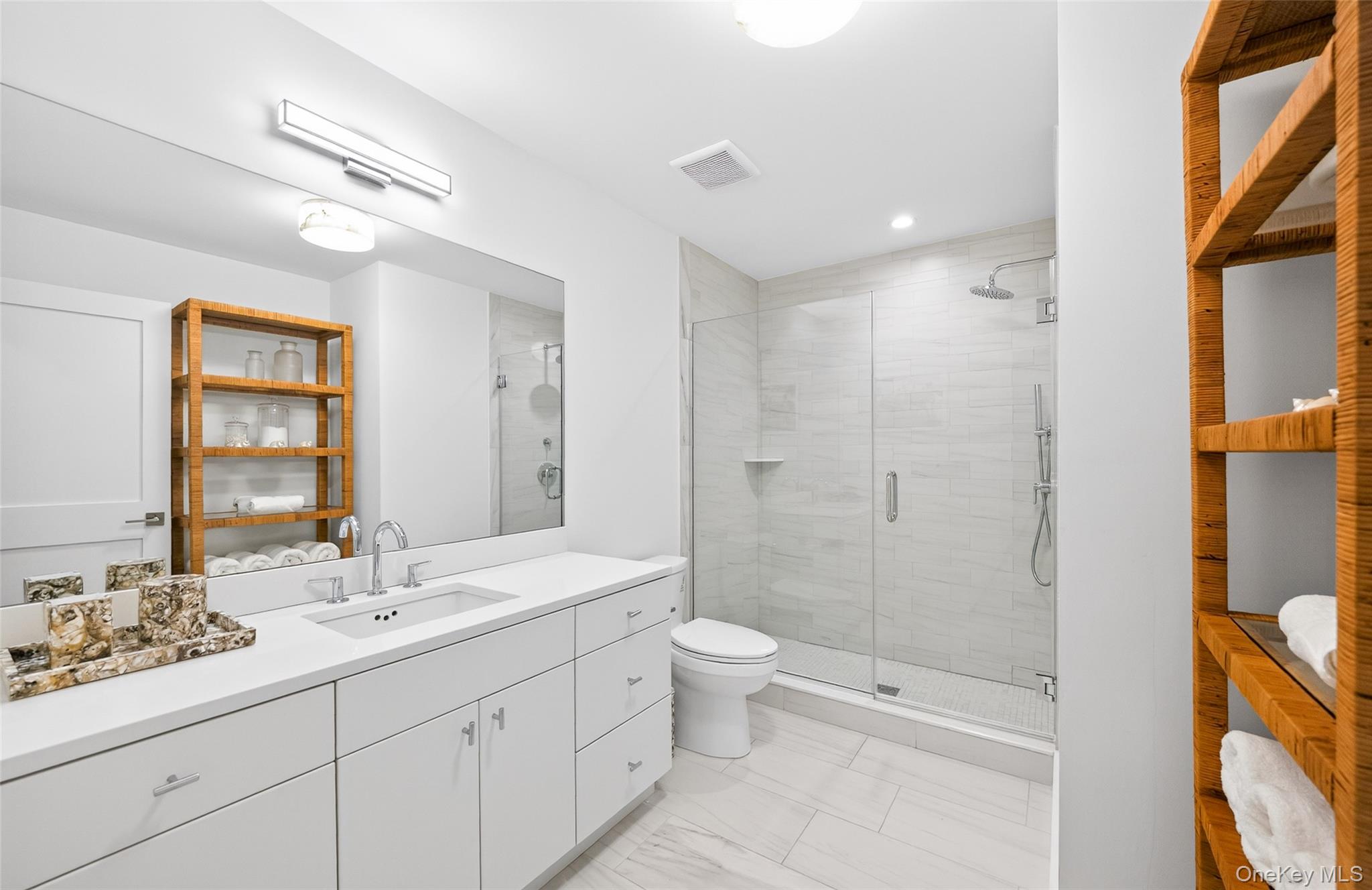 17 Bayview Road Southampton, NY 11968 - Photo 32 of 39 a bathroom with a double vanity sink toilet mirror and shower