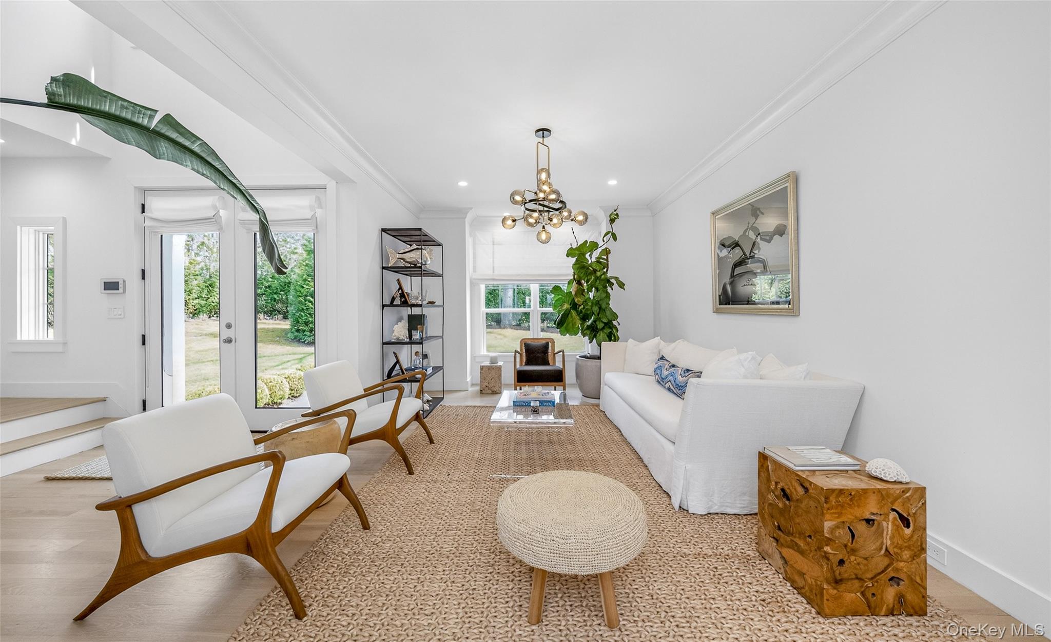 17 Bayview Road Southampton, NY 11968 - Photo 5 of 39 a living room with furniture a chandelier and a table