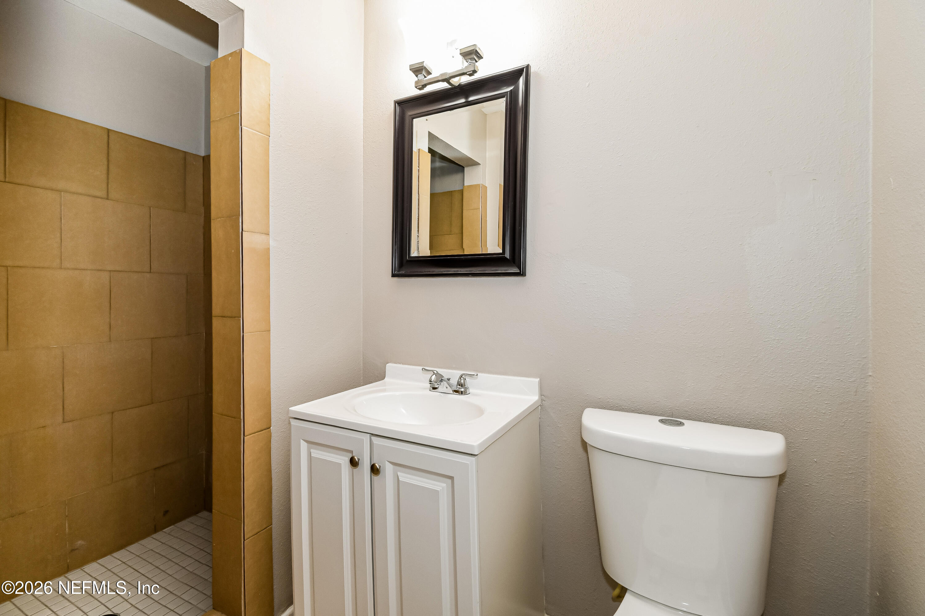 7227 Stonehurst Road North Jacksonville, FL 32277 - Photo 13 of 16 a bathroom with a toilet sink and mirror
