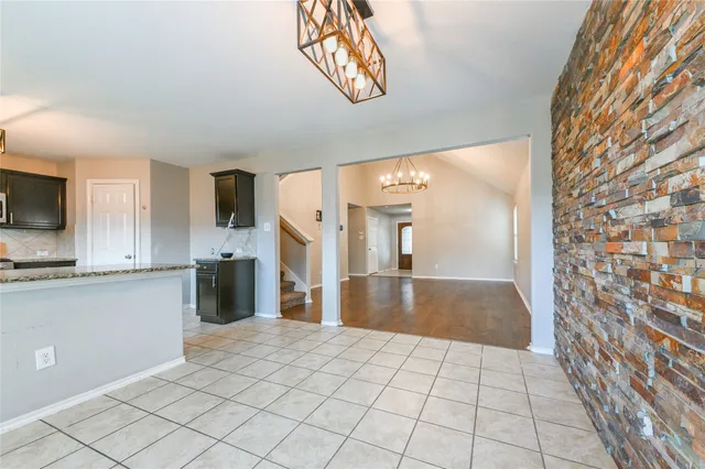 a view of a kitchen with a sink and a refrigerator