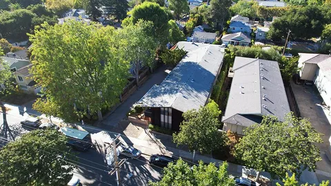 an aerial view of a house with a yard and garden