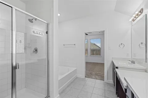 a bathroom with a bathtub shower and sink