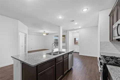 a kitchen with a sink and stove