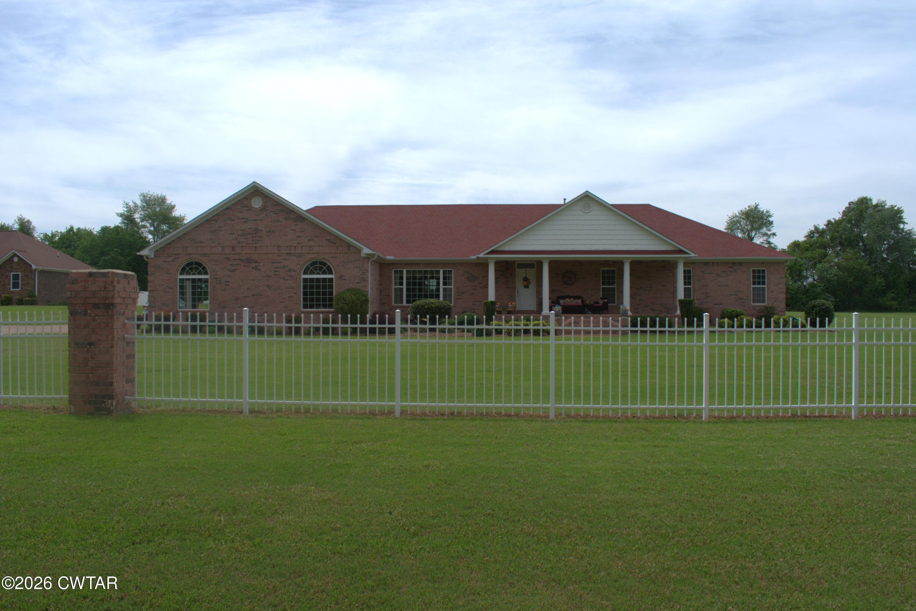 808 Tower Road McKenzie, TN 38201 - Photo 1 of 19 a view of a house with a big yard and garden