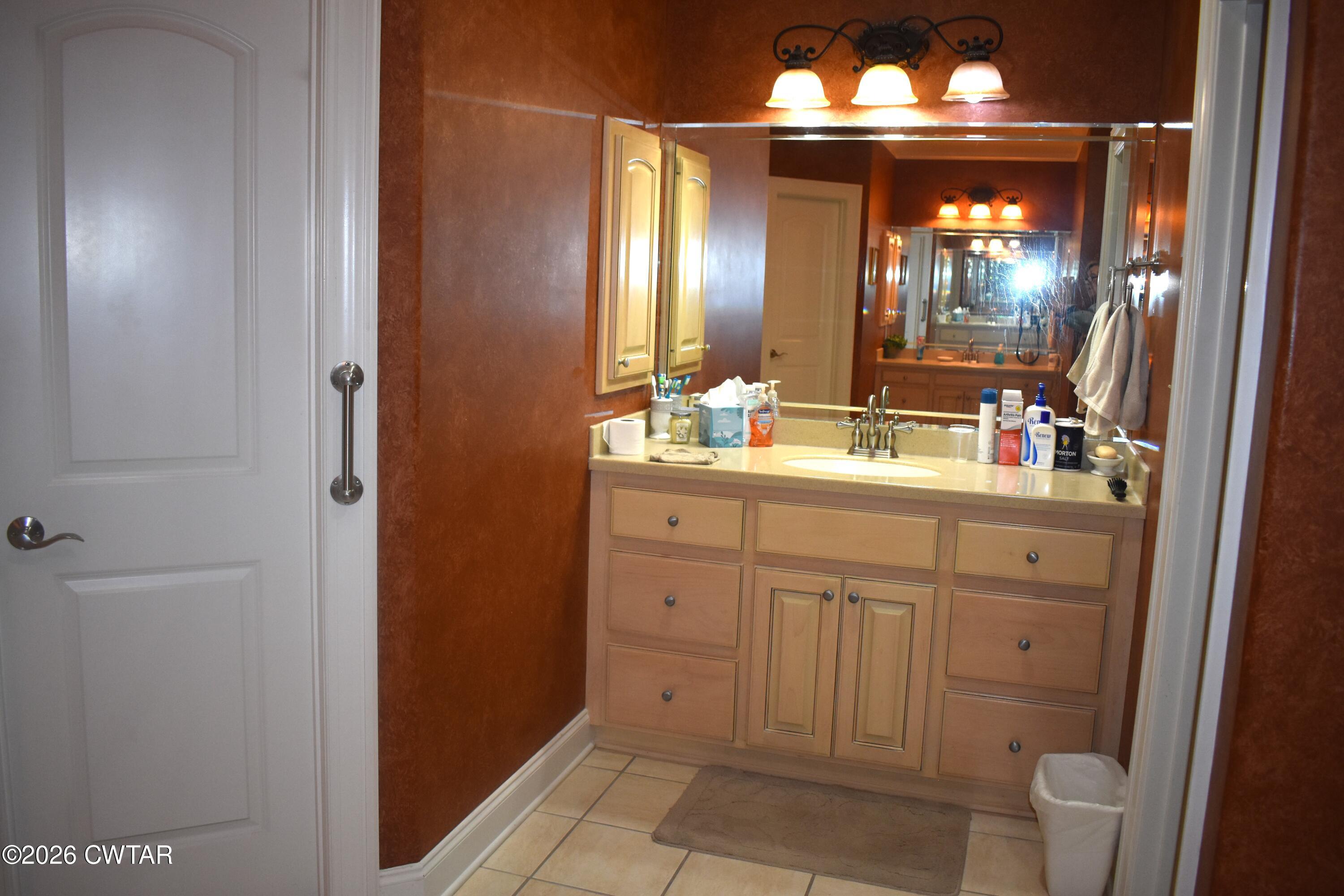 808 Tower Road McKenzie, TN 38201 - Photo 11 of 19 a bathroom with a double vanity sink and a mirror