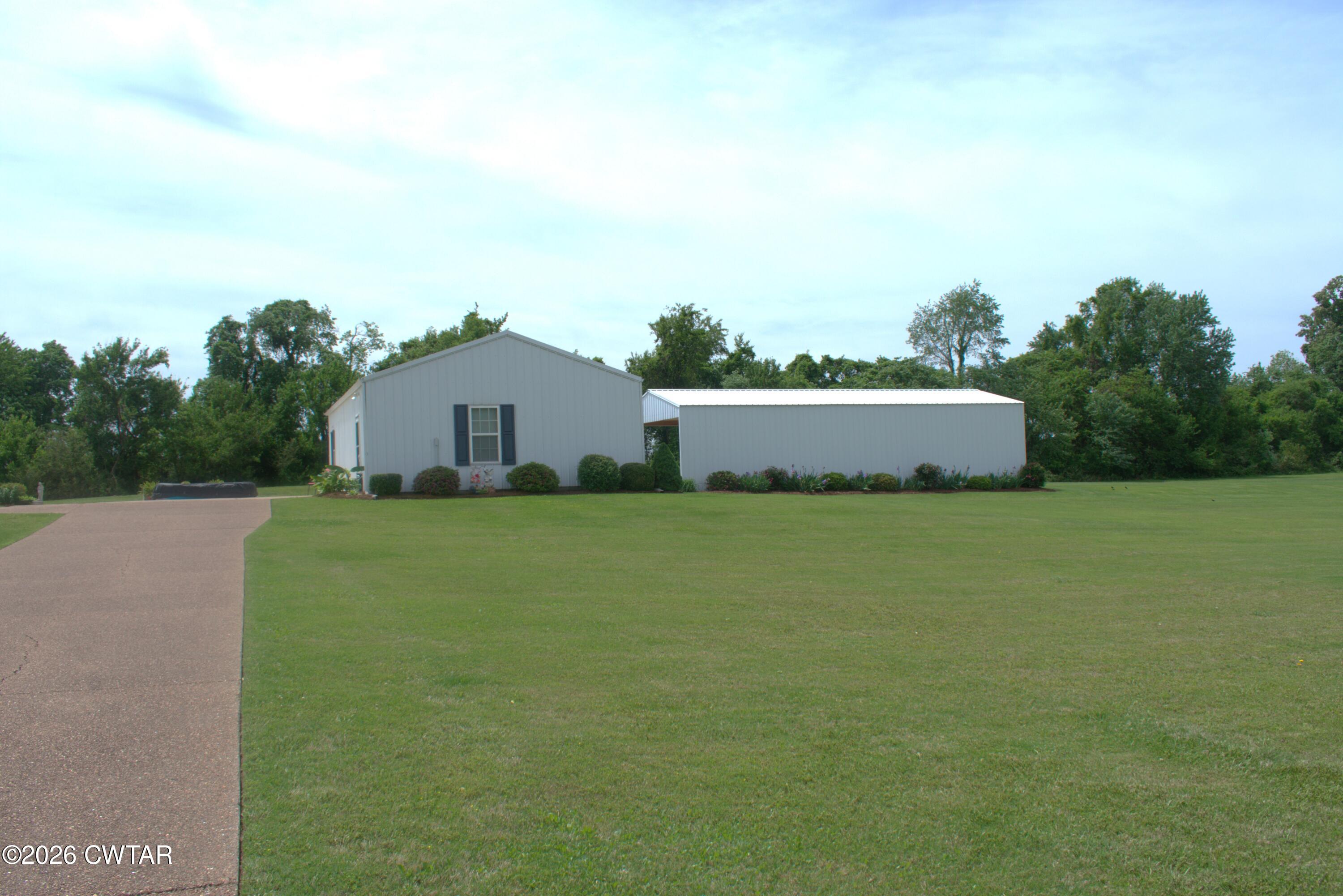 808 Tower Road McKenzie, TN 38201 - Photo 14 of 19 a front view of a house with a garden and yard