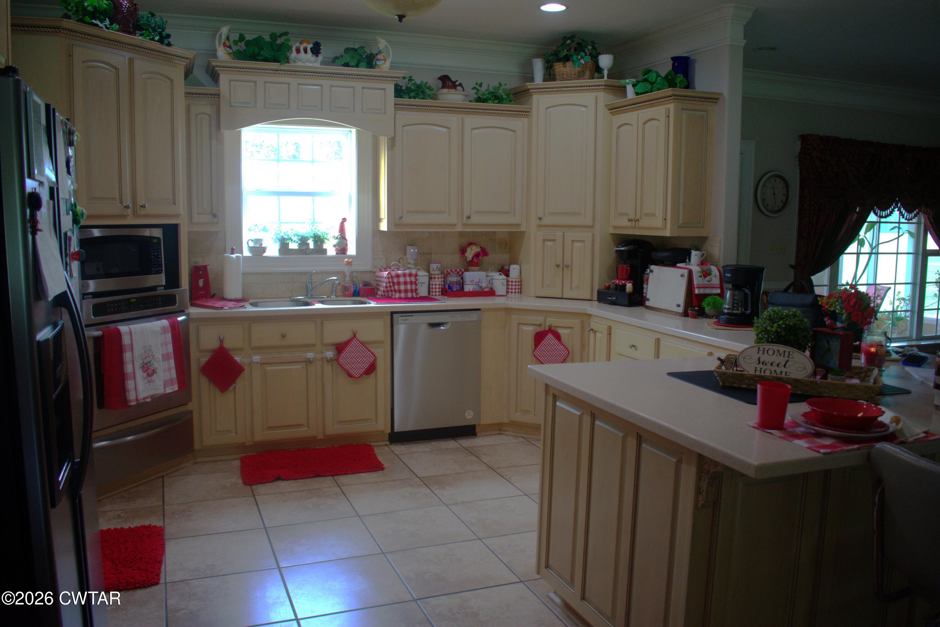 808 Tower Road McKenzie, TN 38201 - Photo 3 of 19 a kitchen with kitchen island granite countertop a sink window and refrigerator