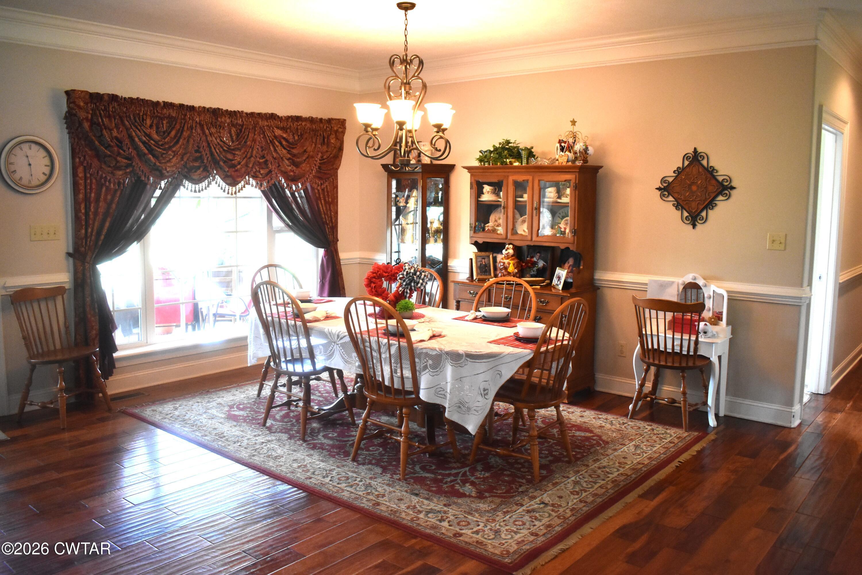 808 Tower Road McKenzie, TN 38201 - Photo 4 of 19 a dining room with furniture a chandelier and wooden floor