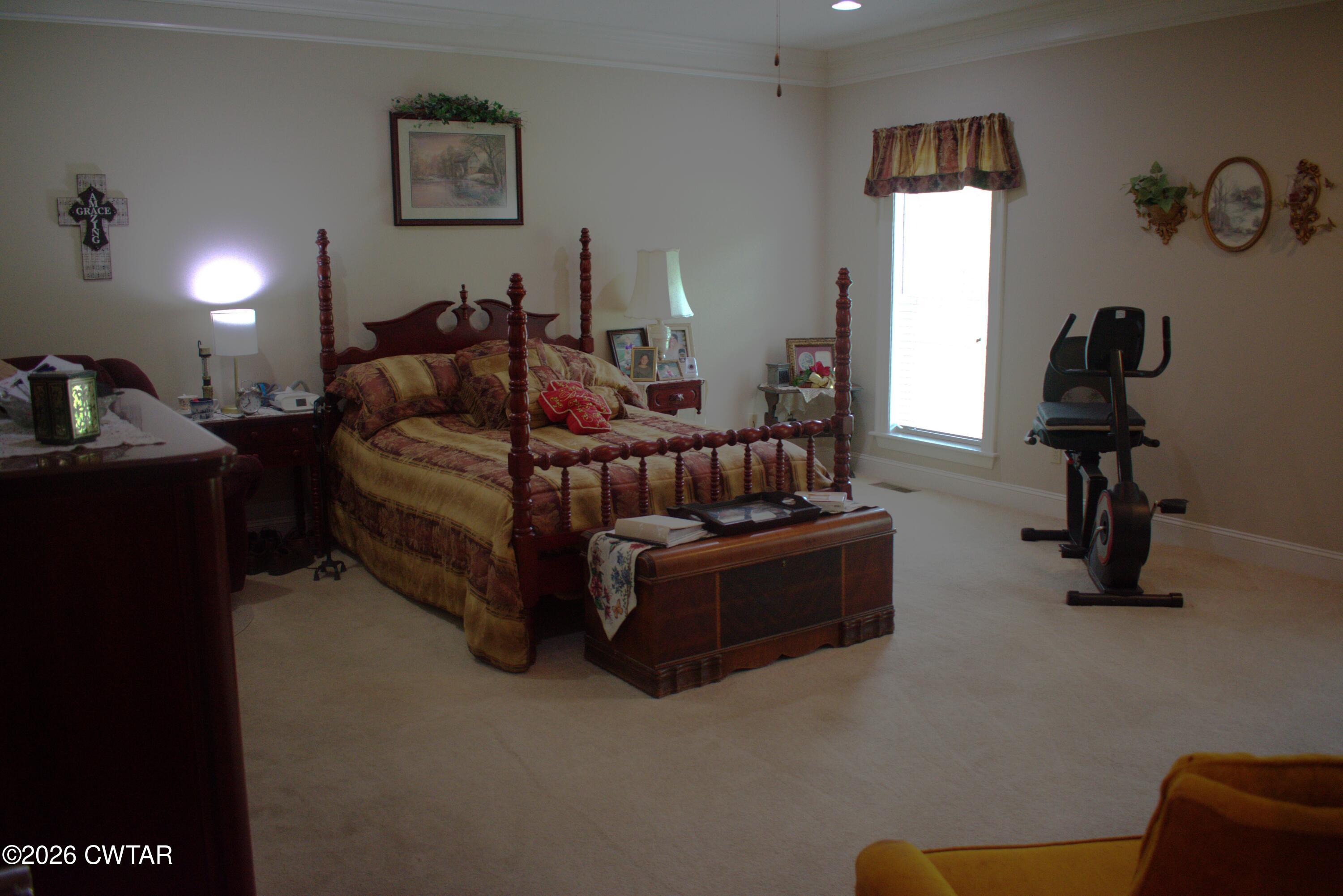 808 Tower Road McKenzie, TN 38201 - Photo 8 of 19 a spacious bedroom with a bed and a couch